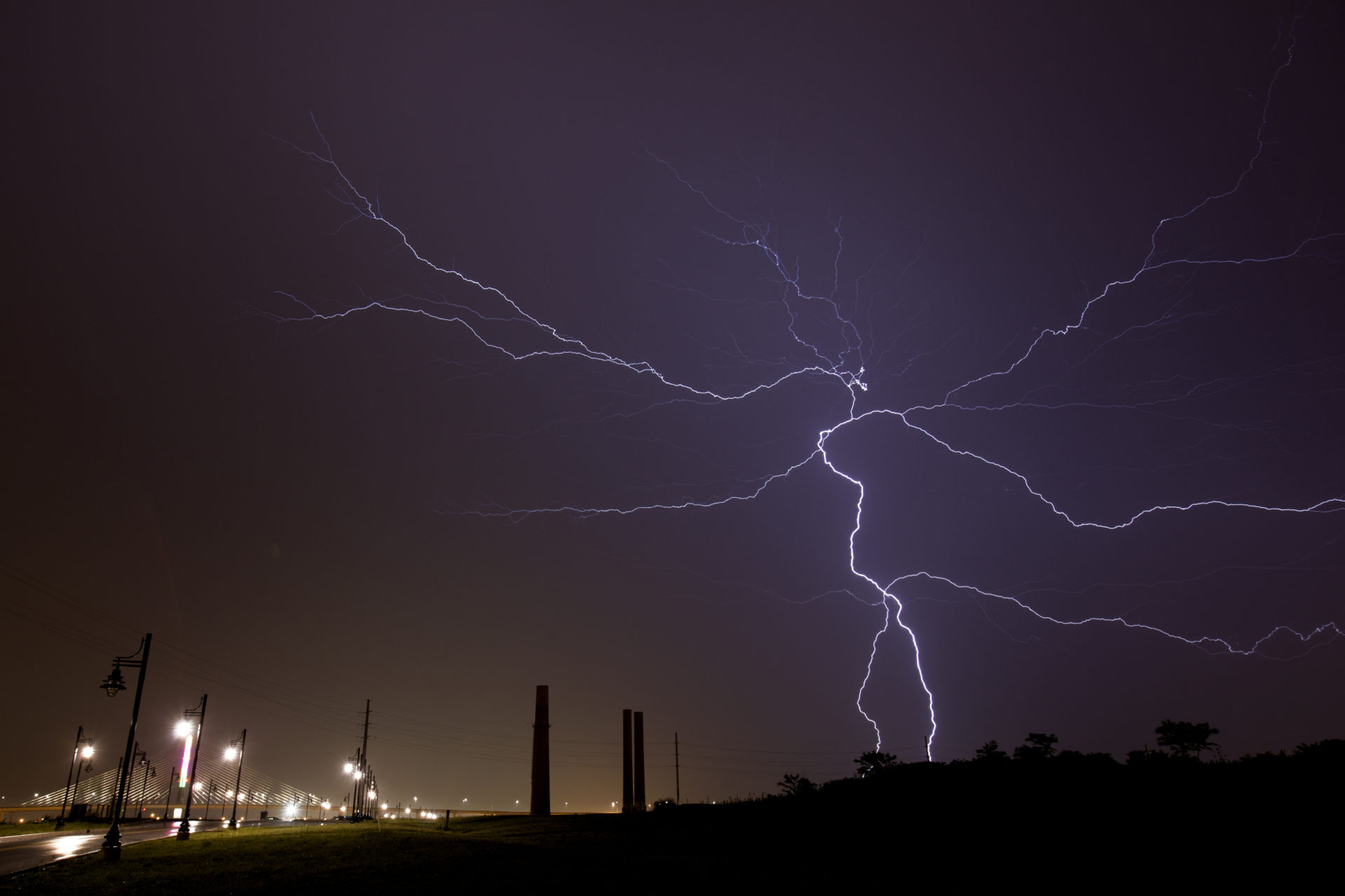 Lightning strikes over an industrial area