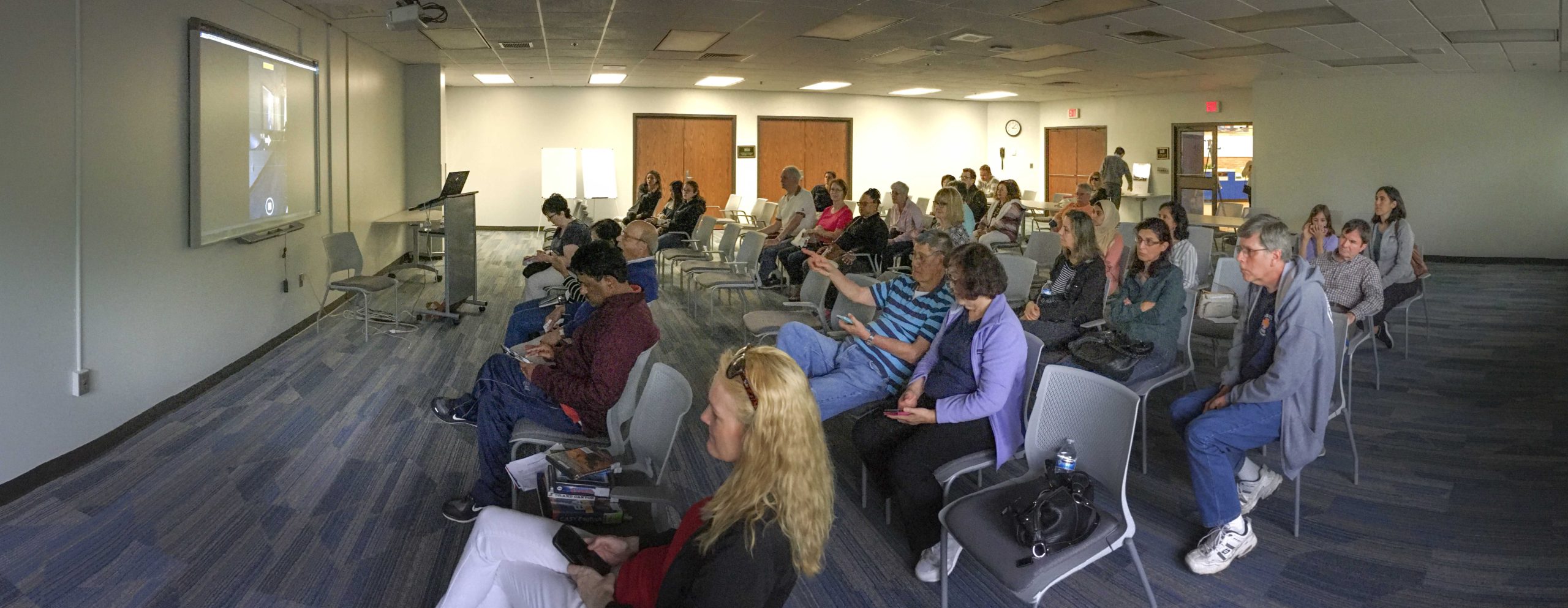 A group sits in a room for a cell phone photography workshop